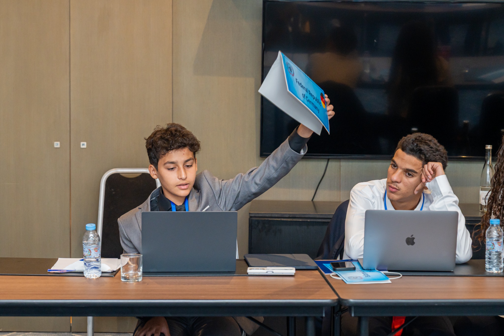 Omar participating in a conference session