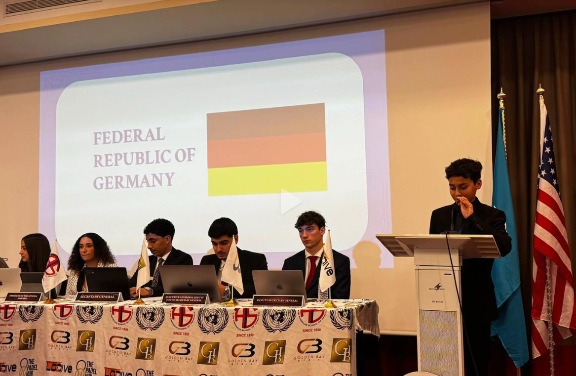 Omar speaking from the podium at a Model United Nations event